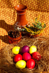 Painted Easter eggs in a nest of straw. Sunlight. Easter still life. - 336483403
