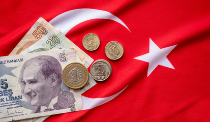 Close-up of Turkish Lira on Turkish Flag. Turkey's donation campaign for the Corona epidemic. We are enough for us my turkey Turkish: Hashtag bizbizeyeteriz Türkiyem.