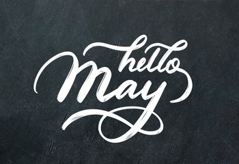 "Hello May" hand lettering inscription on black chalkboard background.