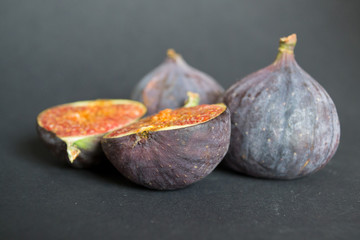 Fresh ripe figs on dark table. Healthy mediterranean fig fruit. Fresh figs on black background.