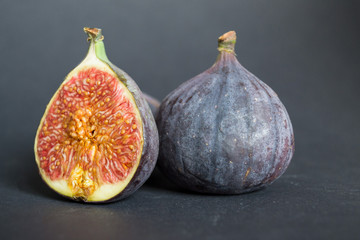 Fresh ripe figs on dark table. Healthy mediterranean fig fruit. Fresh figs on black background.
