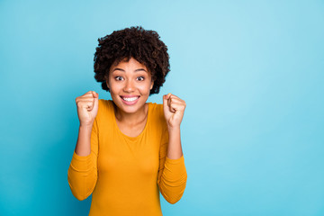 Portrait of positive cheerful excited afro american girl wait for her incredible lottery win...