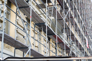 Tall building under construction with scaffolds. Scaffold. Construction Scaffoldings