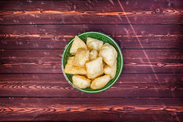 Baursak - traditional Kazakh Asia food national bread in plate on wooden background. Top view