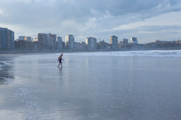 elderly bather on empty urban beach