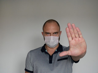 Man with mask to protect him from Coronavirus. Corona virus pandemic. Young man with mask standing....