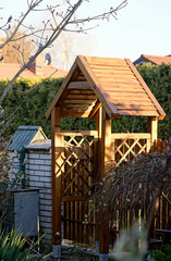 entrance to the property in the shape of a small wooden house with a sloping roof