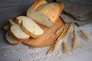 Sliced wheat bread on a wooden background