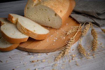 Sliced loaf of bread on a wooden background. Close-up