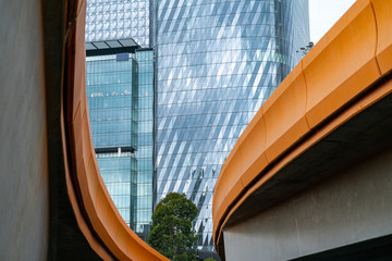 Melbourne Buildings through the curving and converging orange sides of Charles Grimes Bridge across...