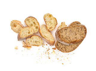 Sliced Multigrain rustic  bread isolated on a white background. Rye Bread with crusty loaves and crumbs. Top view. Flat lay. Bakery Food concept.