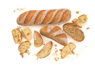 Sliced Multigrain rustic  bread isolated on a white background. Rye Bread with crusty loaves and crumbs. Top view. Flat lay. Bakery Food concept.