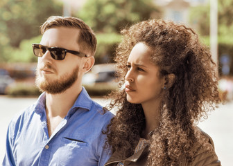 Fototapeta premium Young multiracial couple look serious and frightened