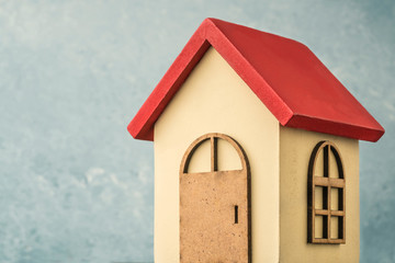 wooden carved house over blue background with copy space