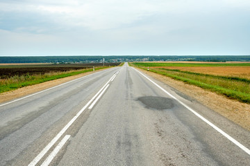 road with patches on the asphalt passing through