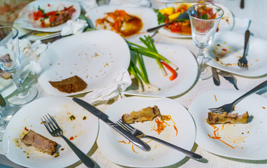 Empty dishes after family dinner in restaurant. Party, celebration or healthy food concept.