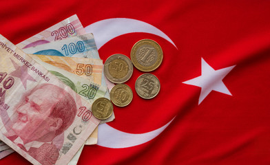 Close-up of Turkish Lira on Turkish Flag. Turkey's donation campaign for the Corona epidemic. We are enough for us my turkey Turkish: Hashtag bizbizeyeteriz Türkiyem.