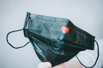Black face mask with a red heart on it