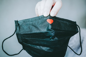 Black face mask with a red heart on it