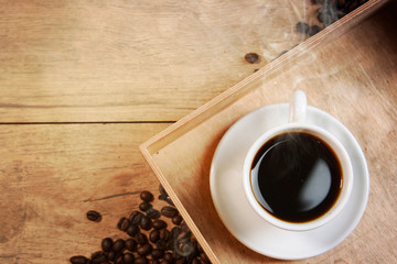 Coffee cup and beans on old kitchen table.