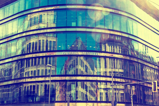 City architecture reflected in glass facade windows of Galeries Lafayette Berlin building, Germany. This building of French architect Jean Nouvel is also called Quartier 207