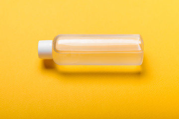 Bottle of antiseptic hand gel isolated on yellow