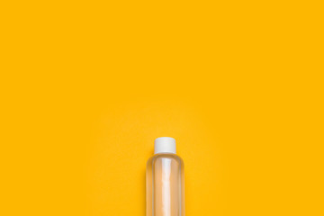 Bottle of antiseptic hand gel isolated on yellow