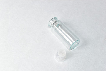 Glass flask with a stopper on a white background with a note medicine