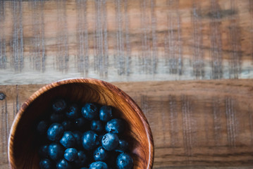 Fresh and healthy blueberries in wooden bowl ready to eat. Healthy lifestyle natural background.