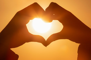 heart with hands towards the sun