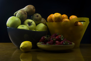 bowls of fresh fruits on wooden table