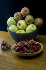 dish with strawberries and bowl winth fresh fruits