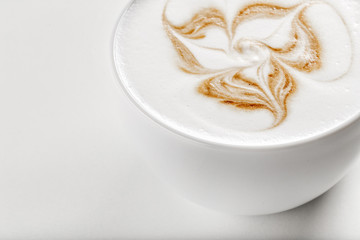 Hot cappuccino with latte art on top in white ceramic mug. White background. Best for commercial.