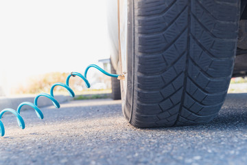 inflating the car tires with air using a compressor