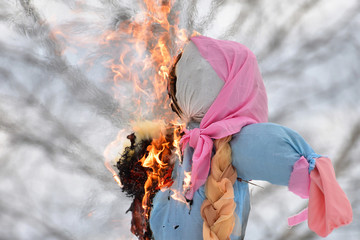 Shrovetide in Russia, burning a scarecrow on the day of winter farewell © denlog