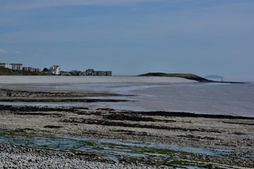 BARRY, VALE OF GLAMORGAN / WALES - APRIL 15 2020: elderly people take daily exercise in the sunshine during the COVID_19 lockdown making sure they are complying with social distance rules