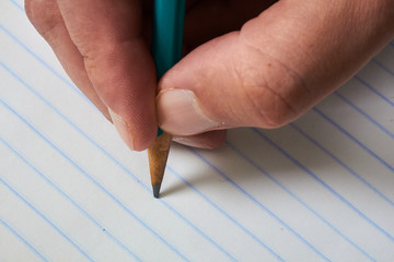 Pencil on a striped sheet. It will be used to draw or write on this notebook.