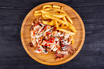 Fried pork meat, served with fries and ketchup with mayonnaise