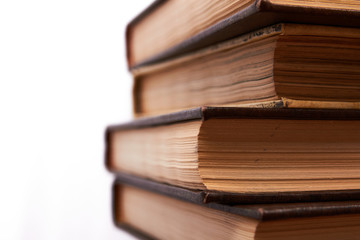 Old books stacked in column. Years of wisdom embodied in encyclopedias.