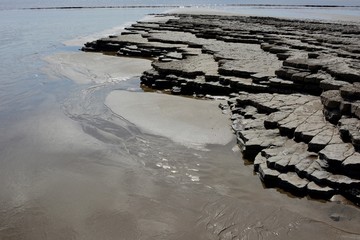 BARRY, VALE OF GLAMORGAN / WALES - APRIL 15 2020: elderly people take daily exercise in the sunshine during the COVID_19 lockdown making sure they are complying with social distance rules