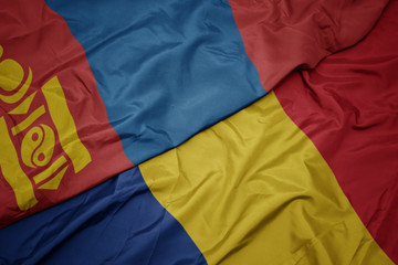waving colorful flag of romania and national flag of mongolia.