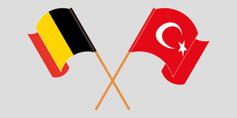 Crossed and waving flags of Turkey and Belgium