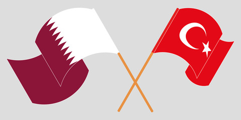 Crossed and waving flags of Turkey and Qatar