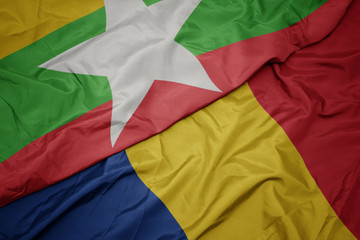 waving colorful flag of romania and national flag of myanmar.
