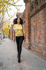 Afro-american woman walking on the street.