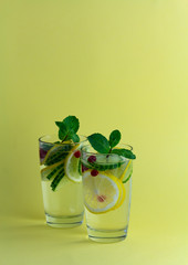 Sassy diet water. Cucumber, lemon, mint lemonade in glasses on light background