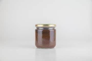 Canned tasty food - Jam jar on white colour background, close up studio object shot. Natural food and healty lyfestyle.