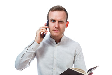 man businessman, teacher, mentor examines entries in your diary and talking on a cell phone....