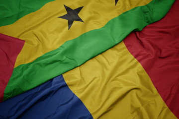 waving colorful flag of romania and national flag of sao tome and principe .