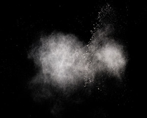 White dust is scattered by an explosion on a black background, an abstract cluster of white particles, a snowstorm on a black background